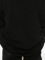 Close up of black hoodie, showing texture of the organic cotton fabric