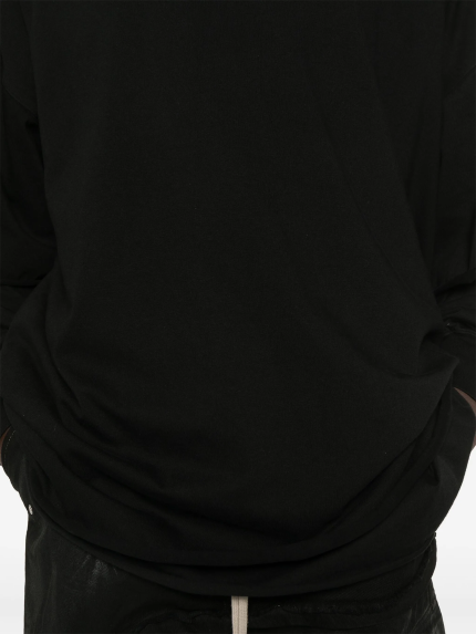 Close up of black hoodie, showing texture of the organic cotton fabric