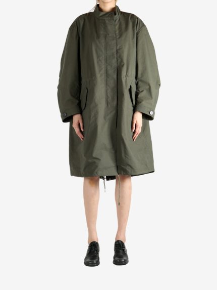 Green coat worn by a person, showing the coat fit