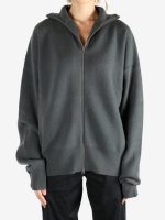 Grey knitwear worn by a person, showing the kintwear's fit