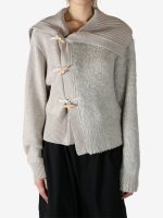 Tan knitwear worn by a person, showing the knitwear fit