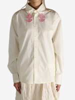 White shirt worn by a person, showing the shirt's fit