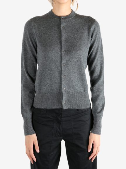 Grey knitwear worn by a person, showing the knitwear's fit
