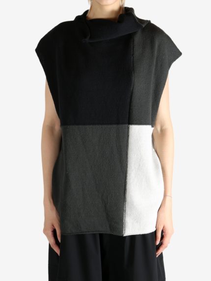 Black top worn by a person, showing the top fit