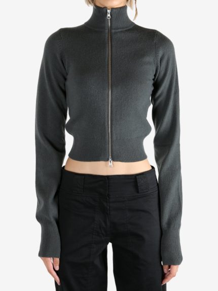 Grey knitwear worn by a person, showing the knitwear's fit