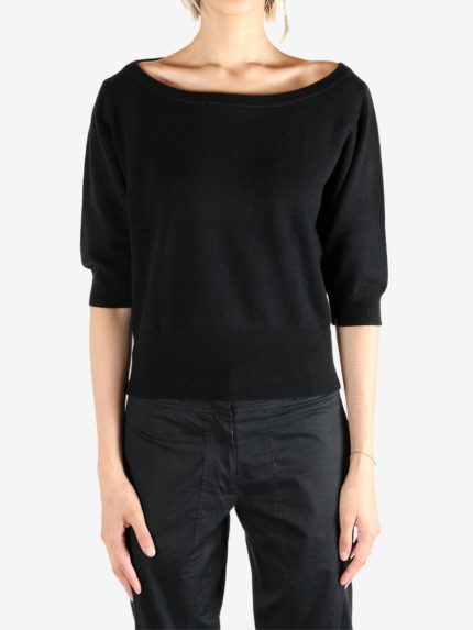 Black knitwear worn by a person, showing the knitwear's fit