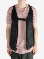 Black vest worn by a person, showing the vest's fit
