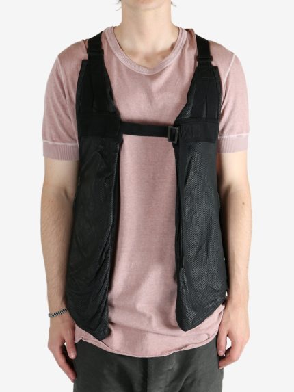 Black vest worn by a person, showing the vest's fit