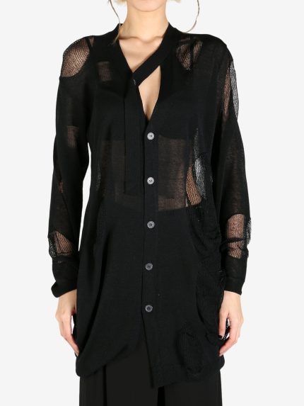 Black knitwear worn by a person, showing the knitwear's fit