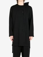 Black shirt worn by a person, showing the shirt's fit