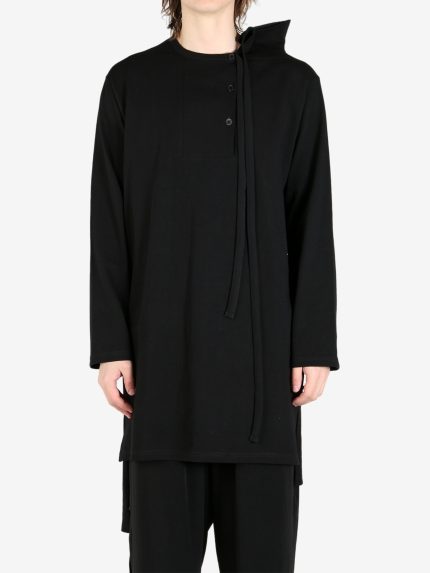 Black shirt worn by a person, showing the shirt's fit