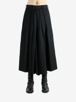 Black pants worn by a person, showing the pants' fit
