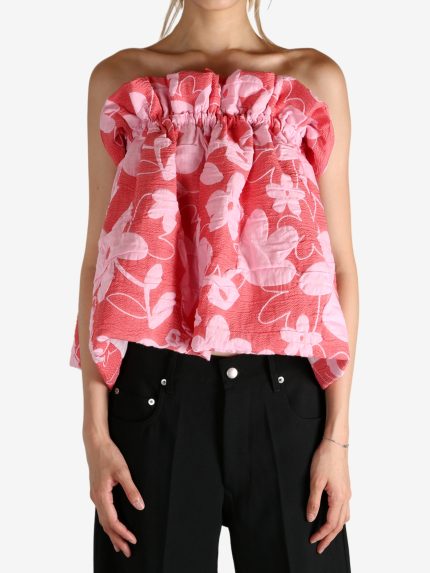 Red top worn by a person, showing the top fit
