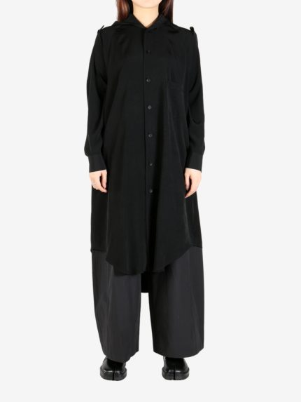 Black dress worn by a person, showing the dress' fit