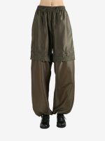 Green pants worn by a person, showing the pants's fit