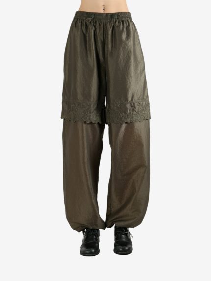 Green pants worn by a person, showing the pants's fit