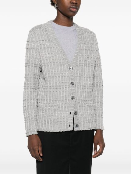 Grey knitwear worn by a person, showing the knitwear’s fit