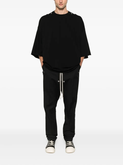 Black t-shirt worn by a person, showing the t-shirt's fit