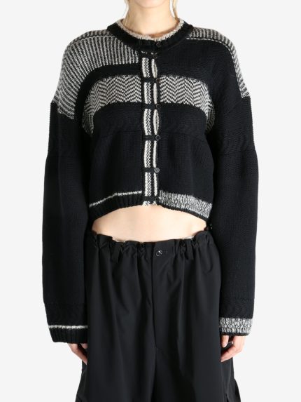 Black knitwear worn by a person, showing the knitwear fit