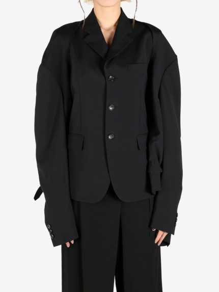 Black jacket worn by a person, showing the jacket's fit